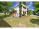 View of the backyard highlighting the grassy lawn and the architectural details of the home's rear at 209 N Occoneechee St, Hillsborough, NC 27278