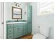 Charming bathroom with colorful vanity, mirror and natural light at 209 N Occoneechee St, Hillsborough, NC 27278