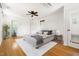 Cozy bedroom with neutral colors, hardwood floors, fan and ensuite bath at 209 N Occoneechee St, Hillsborough, NC 27278
