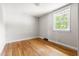 Bedroom with hardwood floors and a window for natural light at 209 N Occoneechee St, Hillsborough, NC 27278