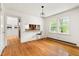 Dining area with view to kitchen, hardwood flooring and bright windows at 209 N Occoneechee St, Hillsborough, NC 27278