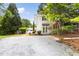 Inviting home with a well-manicured lawn, mature trees, and ample parking at 209 N Occoneechee St, Hillsborough, NC 27278