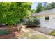 Charming home featuring a well-manicured front yard with lush greenery and mature trees at 209 N Occoneechee St, Hillsborough, NC 27278
