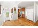 Bright kitchen featuring wooden cabinets, white appliances, and hardwood floors at 209 N Occoneechee St, Hillsborough, NC 27278