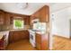Inviting kitchen with wood cabinets, tile counters and access to other rooms at 209 N Occoneechee St, Hillsborough, NC 27278
