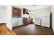 Cozy kitchen features white appliances, wooden cabinets, and vintage flooring at 209 N Occoneechee St, Hillsborough, NC 27278
