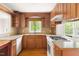Charming kitchen with wood cabinets, tile countertops, and view at 209 N Occoneechee St, Hillsborough, NC 27278