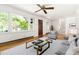 Cozy living room featuring hardwood floors, a large window, and neutral-toned furniture, perfect for relaxation at 209 N Occoneechee St, Hillsborough, NC 27278