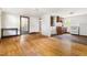 Open-concept living room featuring hardwood floors and an abundance of natural light at 209 N Occoneechee St, Hillsborough, NC 27278