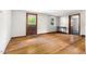 A sun-lit room has original hardwood flooring, neutral walls, and a large window at 209 N Occoneechee St, Hillsborough, NC 27278