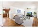 Bright living room with hardwood floors, white walls, and a view into the kitchen, creating an open, inviting space at 209 N Occoneechee St, Hillsborough, NC 27278