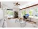 Bright living room featuring hard wood floors, ample natural light, and a home office space at 209 N Occoneechee St, Hillsborough, NC 27278