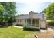 Backyard showcasing a screened-in porch, well-maintained lawn, and classic exterior, perfect for outdoor enjoyment at 210 Needle Park Dr, Cary, NC 27513