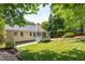 Picturesque backyard featuring a screened-in porch, manicured lawn, and classic home exterior, perfect for outdoor living at 210 Needle Park Dr, Cary, NC 27513