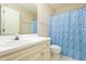 Traditional-style bathroom with white vanity and geometric blue shower curtain at 210 Needle Park Dr, Cary, NC 27513