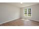 Bedroom with hard wood floors, a window with natural light, and neutral paint at 210 Needle Park Dr, Cary, NC 27513