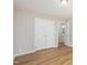 Bedroom with hard wood floors and view of the ensuite bathroom and closet at 210 Needle Park Dr, Cary, NC 27513