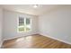 Bedroom with hard wood floors, natural light from the window, and neutral paint at 210 Needle Park Dr, Cary, NC 27513