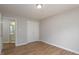 Bedroom with hard wood floors and view to the ensuite bathroom at 210 Needle Park Dr, Cary, NC 27513