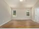Spacious bedroom with two windows and hardwood floors at 210 Needle Park Dr, Cary, NC 27513