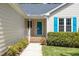 Close-up of home's exterior showing a blue front door and manicured greenery at 210 Needle Park Dr, Cary, NC 27513
