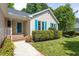 Home's exterior showcasing a blue front door, walkway, and manicured shrubbery at 210 Needle Park Dr, Cary, NC 27513