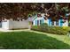 Landscaped front yard with vibrant green grass, mature trees, and blue shuttered home at 210 Needle Park Dr, Cary, NC 27513
