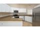 Updated kitchen with white cabinets, stainless steel appliances, and granite countertops at 210 Needle Park Dr, Cary, NC 27513