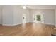 Large, open living room featuring hardwood floors, vaulted ceilings, and recessed lighting at 210 Needle Park Dr, Cary, NC 27513