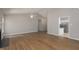 Bright living room with hardwood floors flowing into an adjacent kitchen at 210 Needle Park Dr, Cary, NC 27513