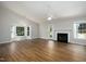 Spacious living room with vaulted ceilings, fireplace, and large windows with hardwood floors at 210 Needle Park Dr, Cary, NC 27513