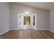 Bright living room featuring vaulted ceilings, hardwood floors, and a large bay window at 210 Needle Park Dr, Cary, NC 27513