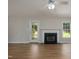 Bright living room featuring a fireplace, ceiling fan, and hardwood floors at 210 Needle Park Dr, Cary, NC 27513