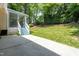 Rear patio features screened in porch with stairs to the yard, perfect for outdoor entertaining and relaxation at 210 Needle Park Dr, Cary, NC 27513