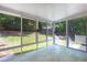 Enclosed sunroom with large windows offering views of the landscaped backyard at 210 Needle Park Dr, Cary, NC 27513