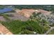 This aerial shows an area with wooded and cleared land, and a neighborhood nearby at 2102 Courtland Dr, Sanford, NC 27330