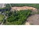 Aerial view of a wooded lot undergoing development with homes being constructed nearby at 2102 Courtland Dr, Sanford, NC 27330