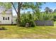 Exterior view of the home's backyard and side with mature trees and privacy at 2102 Courtland Dr, Sanford, NC 27330