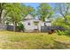 Exterior view of the back of the home with a wooden fence and mature trees at 2102 Courtland Dr, Sanford, NC 27330