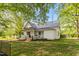 This lovely home has a manicured lawn, metal roof, and quaint porch at 2102 Courtland Dr, Sanford, NC 27330