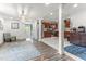 Bright open-concept living room leading to a kitchen and stainless-steel appliances at 2102 Courtland Dr, Sanford, NC 27330