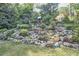 Lush backyard with attractive stone retaining wall and swing set at 220 Glenhill Ln, Chapel Hill, NC 27514