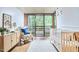 Bright Bedroom room with a white crib, a patterned armchair, and large windows overlooking the wooded yard at 220 Glenhill Ln, Chapel Hill, NC 27514