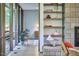 View into a stylish bedroom featuring patterned wallpaper, a wooden dresser, and large windows at 220 Glenhill Ln, Chapel Hill, NC 27514