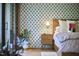 Modern bedroom with patterned wallpaper, sleek furniture, and natural light from large windows at 220 Glenhill Ln, Chapel Hill, NC 27514