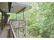Side angle view of a wood deck overlooking a lush green forest at 220 Glenhill Ln, Chapel Hill, NC 27514