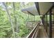 Spacious wood deck offering a tranquil retreat surrounded by lush green trees at 220 Glenhill Ln, Chapel Hill, NC 27514