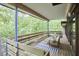 Elevated deck with lounge area provides stunning views of the lush surrounding forest at 220 Glenhill Ln, Chapel Hill, NC 27514