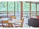 Dining area with an oval table and wood chairs, featuring a view to the outside deck at 220 Glenhill Ln, Chapel Hill, NC 27514