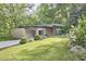 Modern single story home featuring a stylish carport, minimalist design, and lush green lawn at 220 Glenhill Ln, Chapel Hill, NC 27514